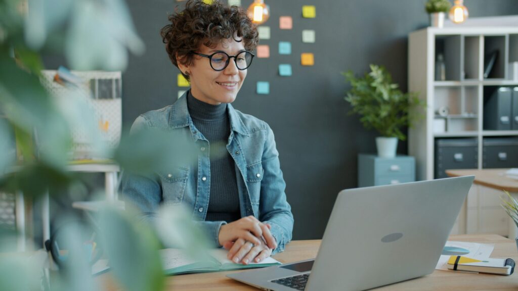 A young woman working in a home office.